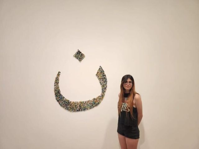 New York City high school student Noor Muhsin, 17, poses in an art gallery wearing a Beatles tank top.